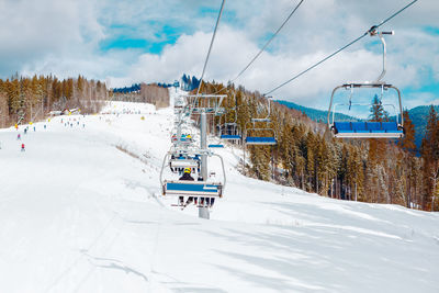 Ski slope resort . ski lift connection . snowy mountains and forest