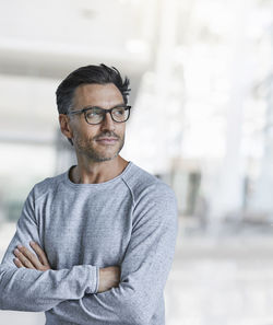 Portrait of content mature man with stubble wearing glasses