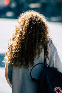 Rear view of woman with umbrella in winter