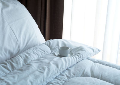 Midsection of man resting on bed at home