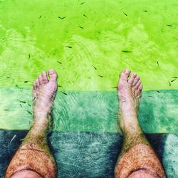 Low section of man relaxing on water