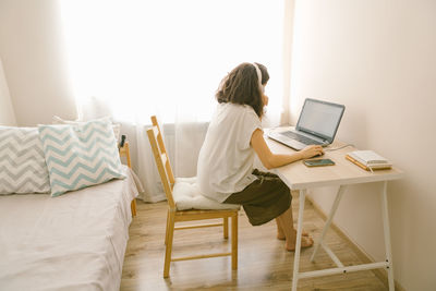 Woman using laptop at home