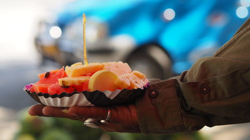 Close-up of hand holding ice cream