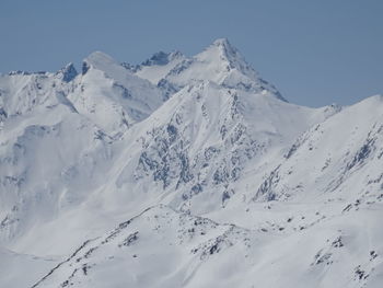 Scenic view of snow covered mountains against sky