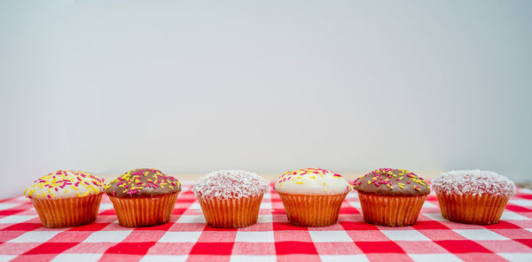 Close-up of cupcakes on table against white background