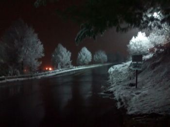 View of illuminated street lights at night