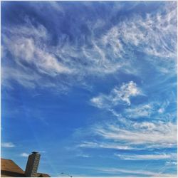 Low angle view of building against cloudy sky