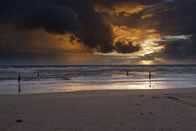Scenic view of beach against sky during sunset