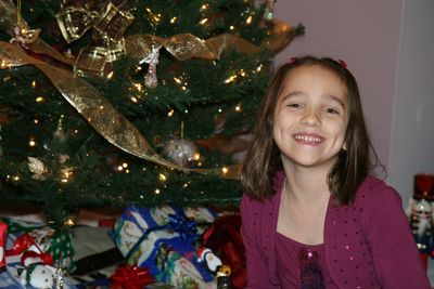 Portrait of smiling girl with christmas tree