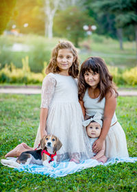 Portrait of smiling girl with dog on lawn