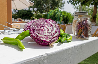 Close-up of vegetables by jar of spices on table