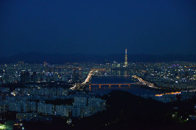 High angle view of illuminated buildings in city at night