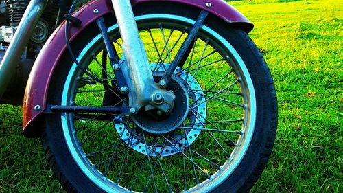 Close-up of bicycle wheel on field