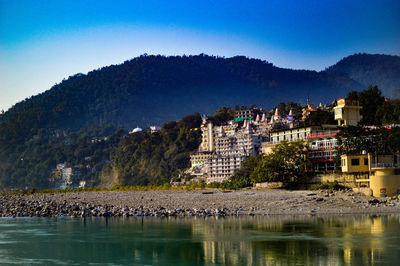 River by trees against clear sky