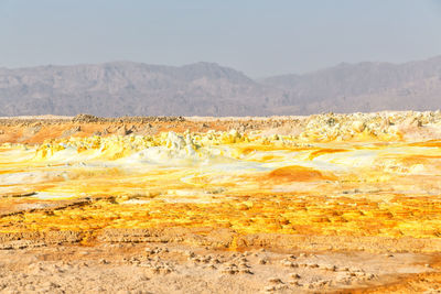 Scenic view of arid landscape against sky