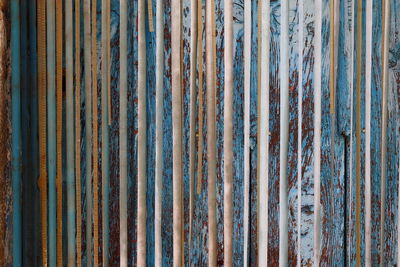 Detail of old curtains in front of rustic wooden door