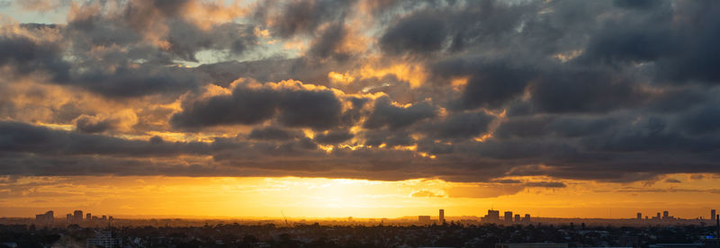 Panoramic view of buildings against sky during sunset