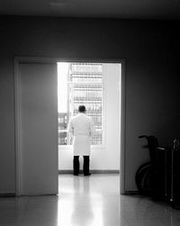 Rear view of man standing in corridor