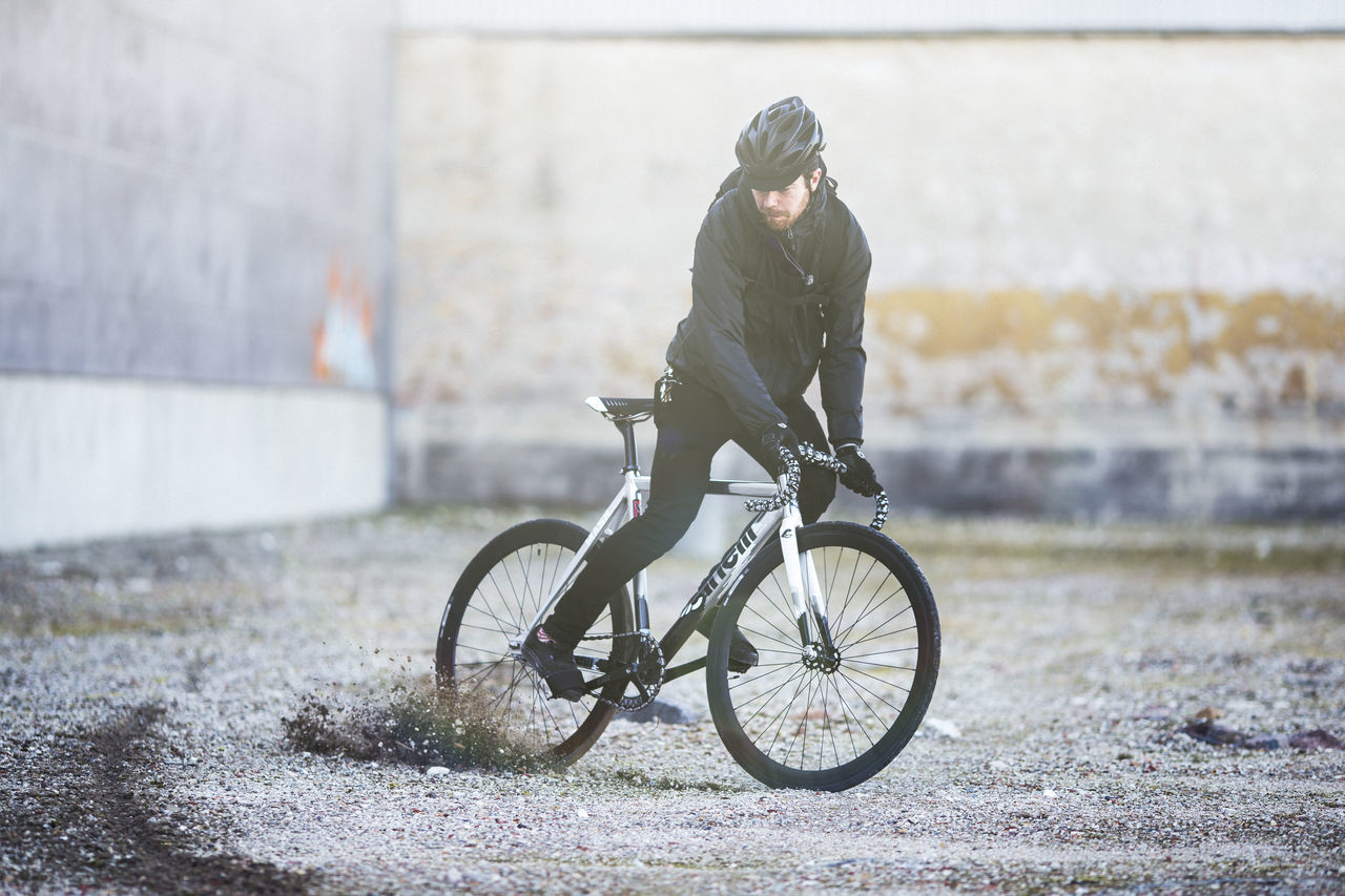 bicycle, transportation, land vehicle, riding, mode of transport, side view, full length, leisure activity, outdoors, day, lifestyles, men, street, stationary, focus on foreground, horse, wall - building feature, cycling