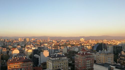 High angle view of illuminated cityscape against sky during sunset