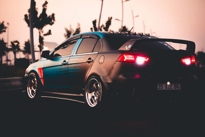 Vintage car on street at sunset