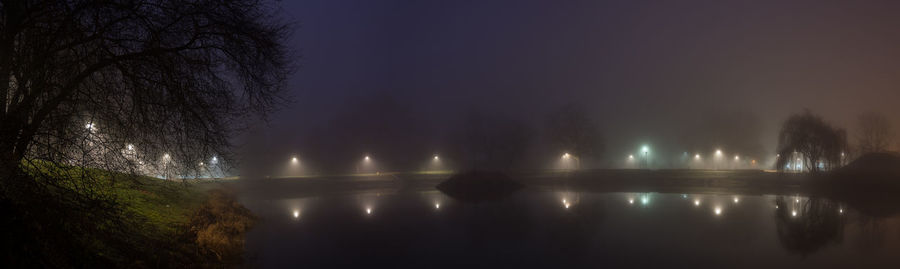 Scenic view of lake against sky at night