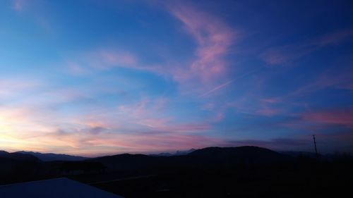 Scenic view of silhouette mountains against sky at sunset