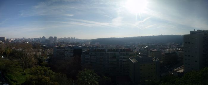 View of cityscape against cloudy sky