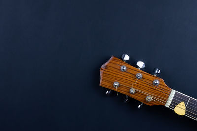 High angle view of guitar against black background