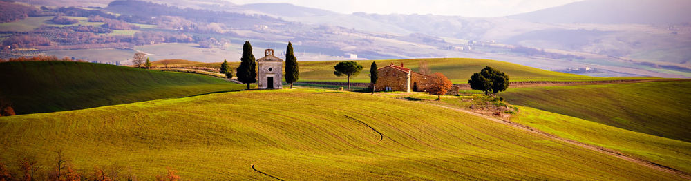 Scenic view of field and mountains against sky