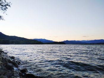 Scenic view of sea against clear sky during sunset