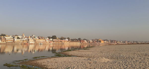 Panoramic view of beach and buildings against clear sky