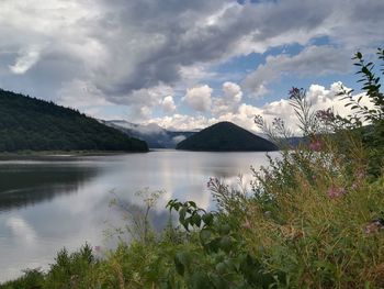 Scenic view of lake and mountains against sky