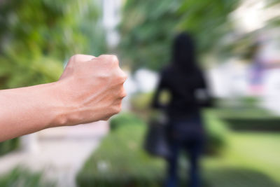 Cropped image of people hand on blurred background