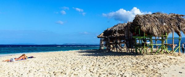 Scenic view of beach against blue sky