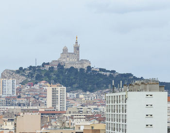 Buildings in city against sky