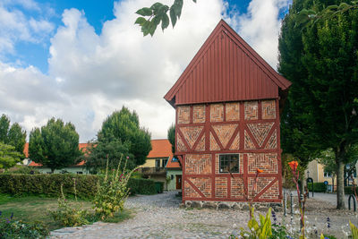 House by trees against sky