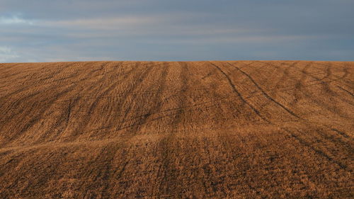 Scenic view of arid landscape against sky