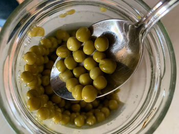 High angle view of green pea in container on table