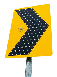 Close-up of yellow sign on white background