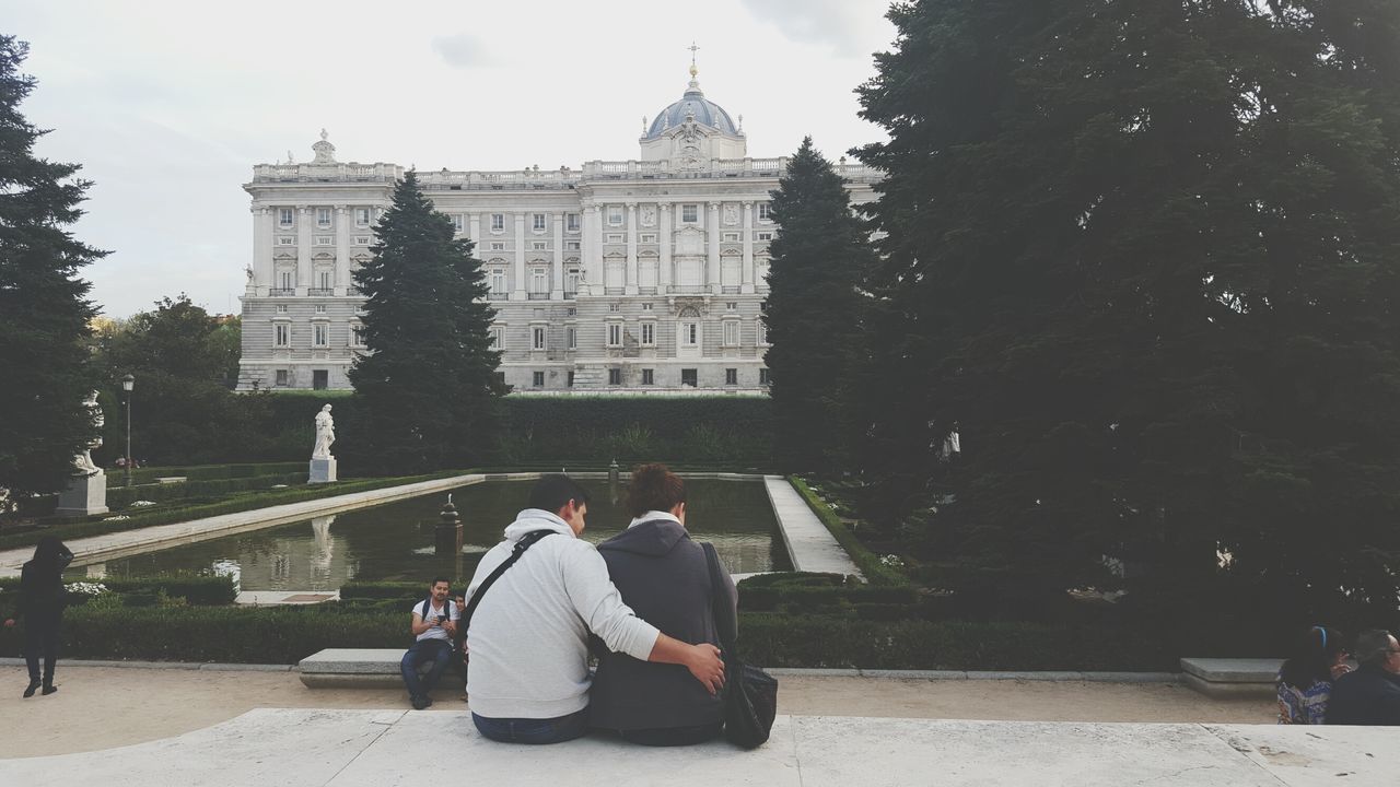 architecture, lifestyles, building exterior, built structure, men, leisure activity, person, rear view, tourism, travel destinations, tourist, famous place, travel, history, sky, tree, casual clothing, walking