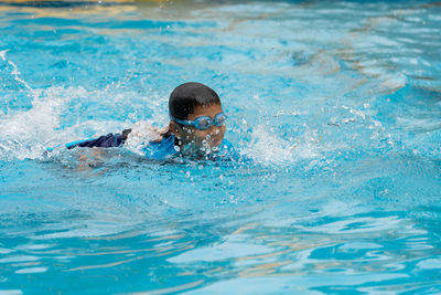 Boy swimming in pool