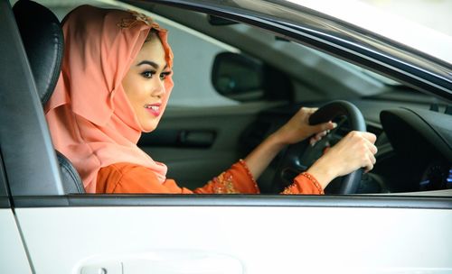 Portrait of woman sitting in car