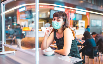 Young woman drinking coffee at cafe