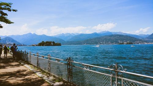 Scenic view of sea and mountains against sky