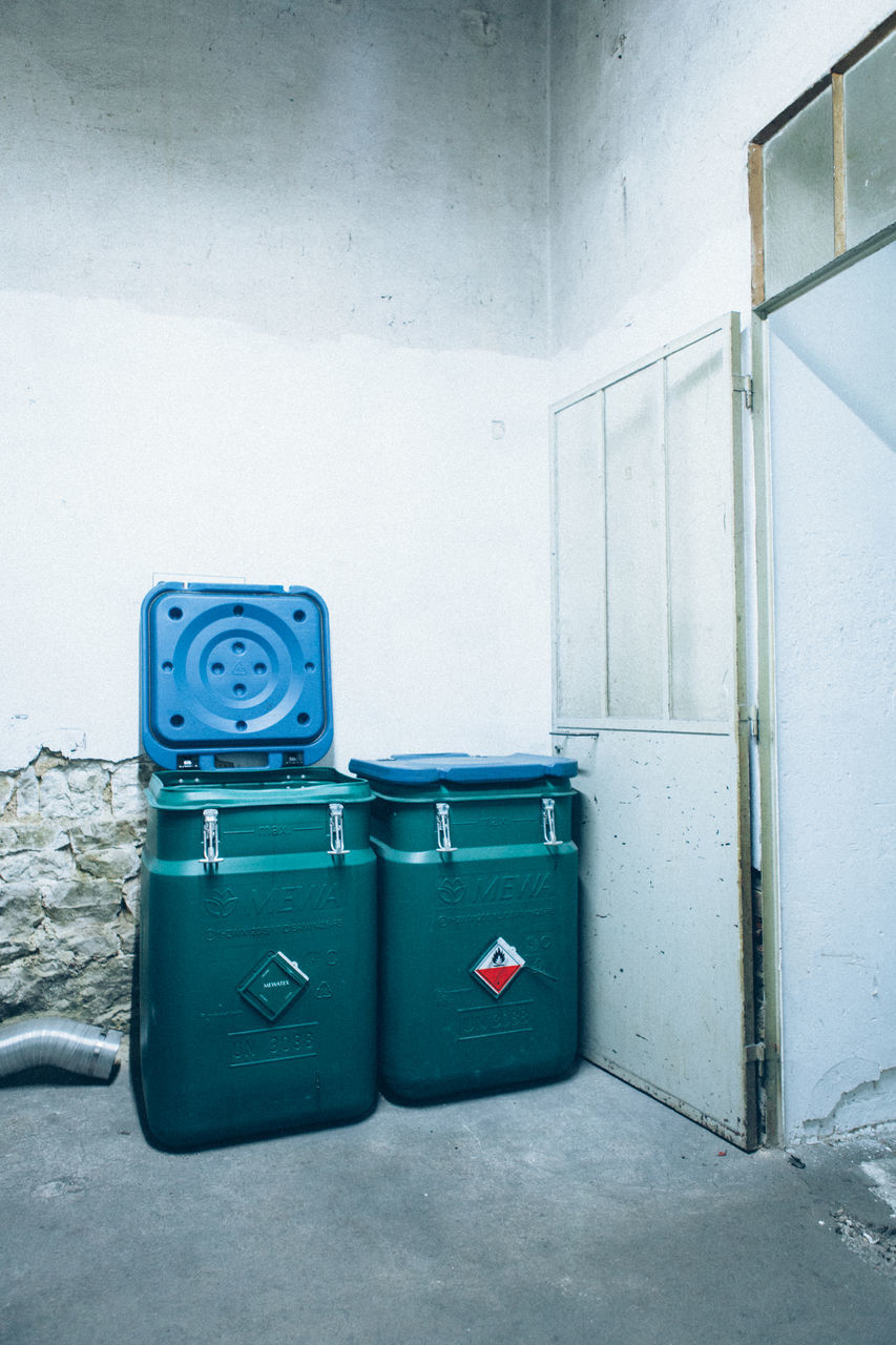 no people, garbage bin, wall - building feature, indoors, blue, architecture, day, safety, garbage can, built structure, recycling, security, technology, container, flooring, recycling bin, still life, protection, plastic