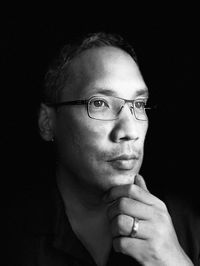 Portrait of man wearing eyeglasses against black background