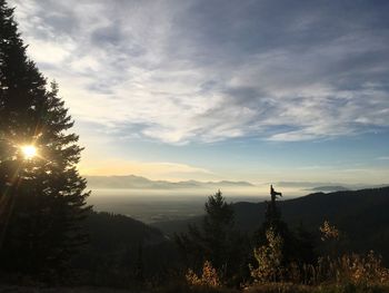 Scenic view of silhouette mountains against sky at sunset