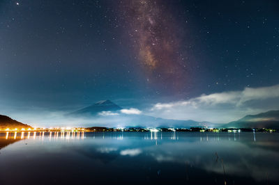 Scenic view of lake against sky at night