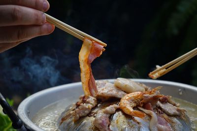 Thailand style bbq grill on a charcoal fire that is located on the bottom with pork, shrimp, squid 